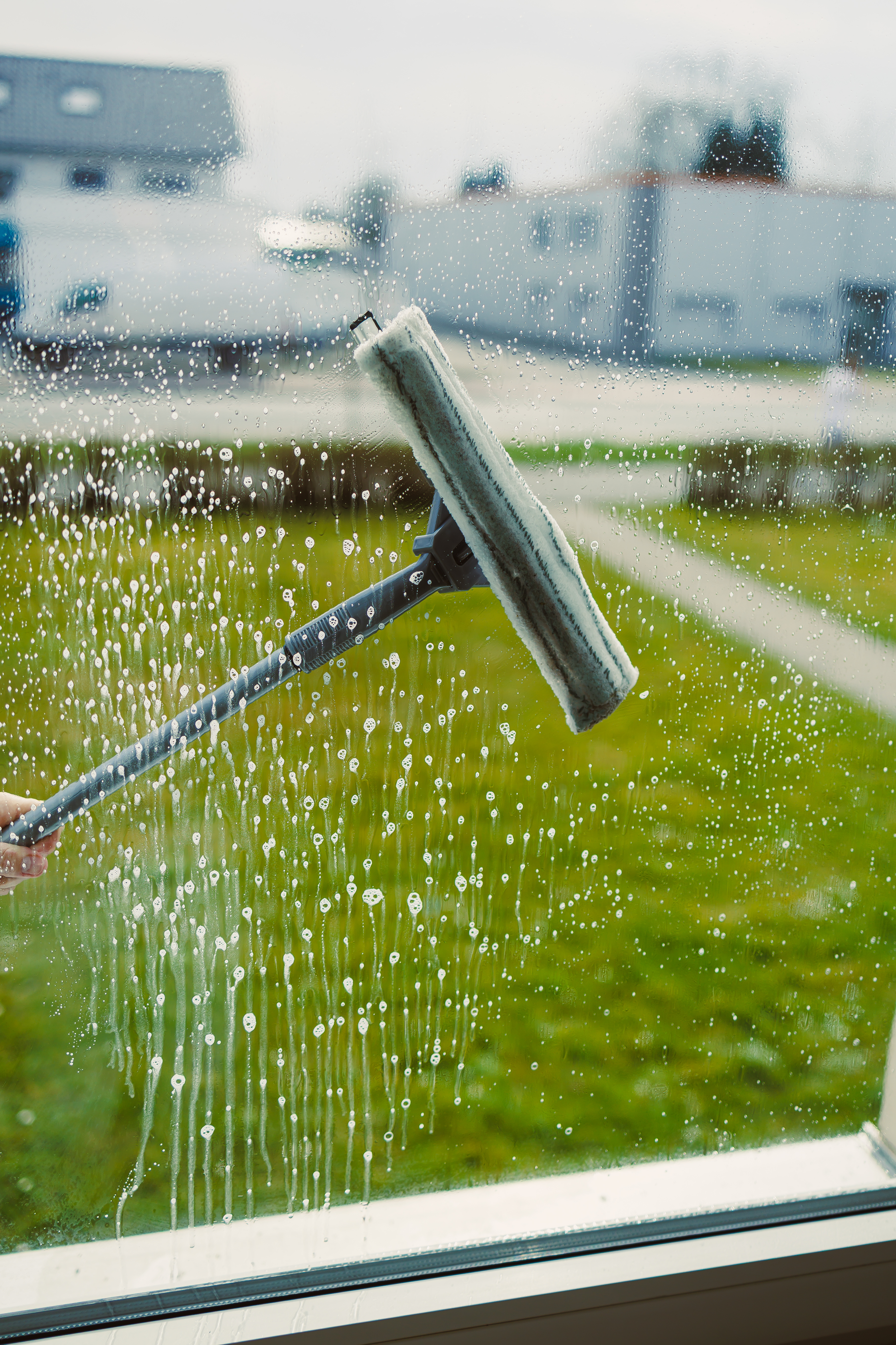 Residential window washing with professional squeegee